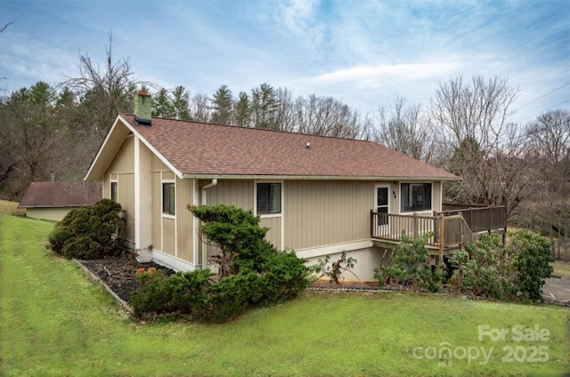 exterior space featuring a lawn and a deck