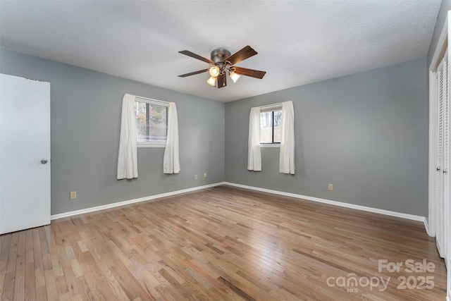 spare room featuring ceiling fan, a textured ceiling, and light hardwood / wood-style floors