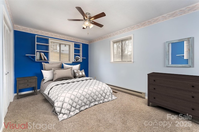 bedroom featuring light carpet, a baseboard heating unit, a closet, and ceiling fan