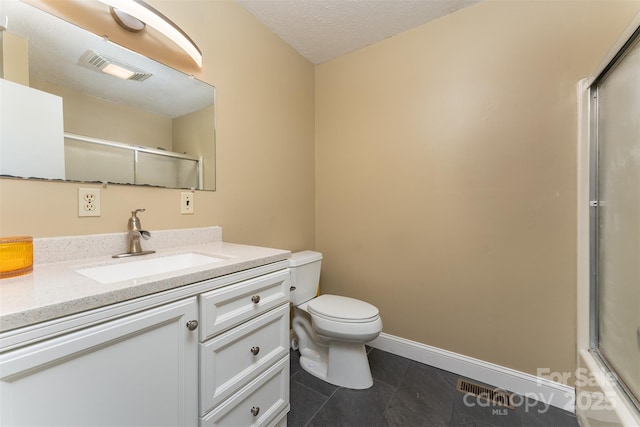 bathroom featuring vanity, toilet, tile patterned flooring, and a textured ceiling