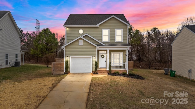 front of property featuring a garage, a yard, covered porch, and central air condition unit