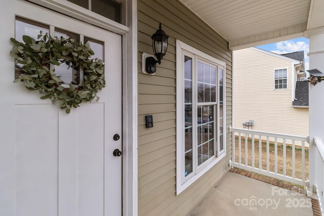 view of exterior entry featuring a porch