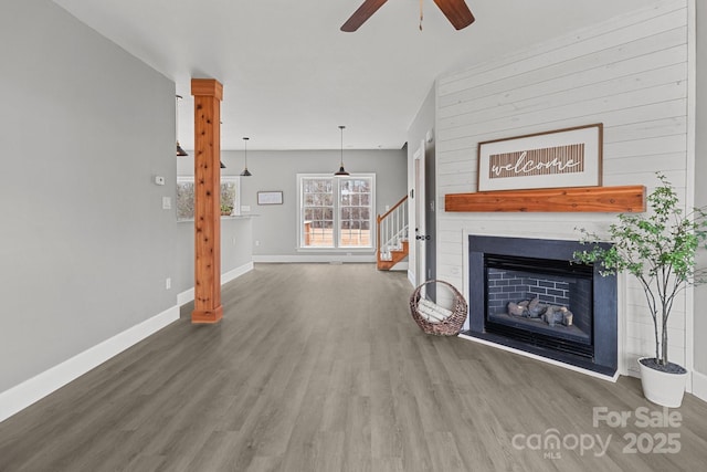 unfurnished living room featuring dark hardwood / wood-style flooring and ceiling fan