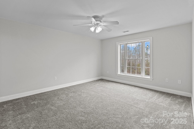 spare room featuring ceiling fan and carpet flooring