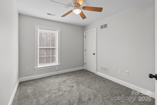 carpeted spare room with ceiling fan