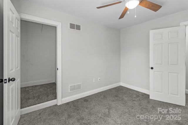 unfurnished bedroom featuring ceiling fan and dark carpet