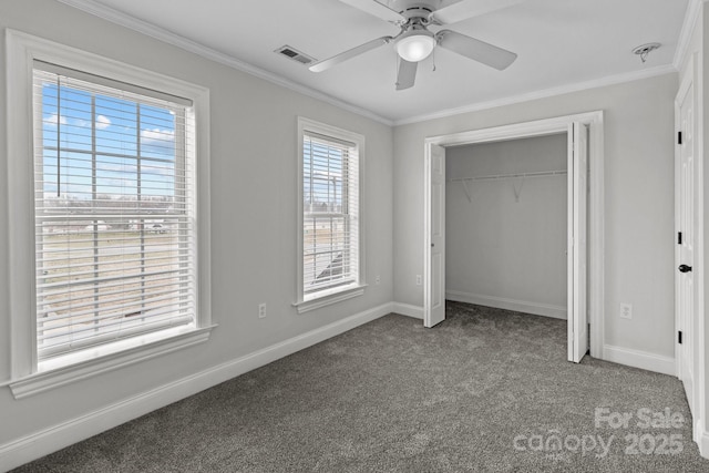 unfurnished bedroom featuring crown molding, a closet, ceiling fan, and carpet flooring