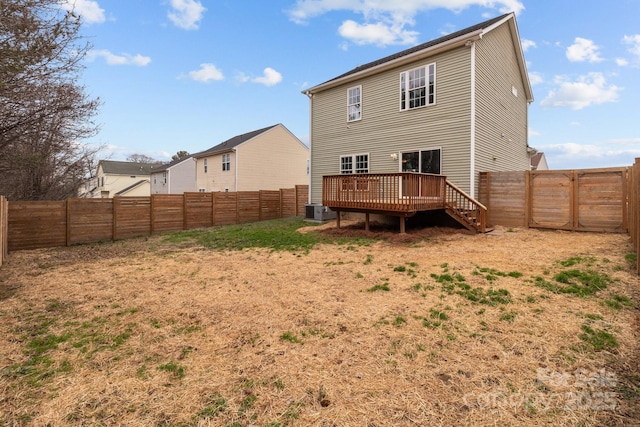 rear view of house featuring cooling unit and a deck