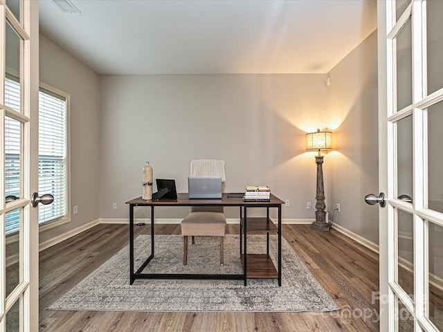 office space with hardwood / wood-style floors and french doors