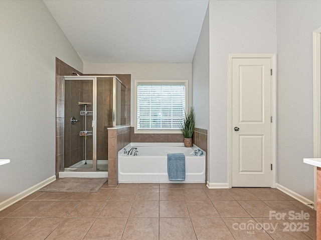 bathroom with lofted ceiling, tile patterned flooring, and shower with separate bathtub