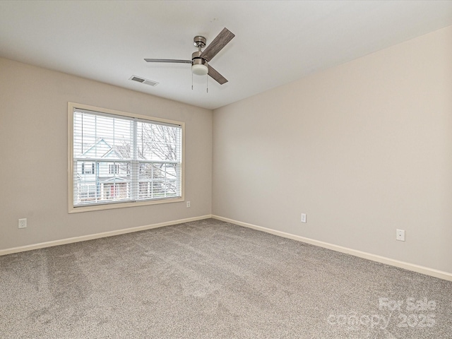 carpeted empty room featuring ceiling fan