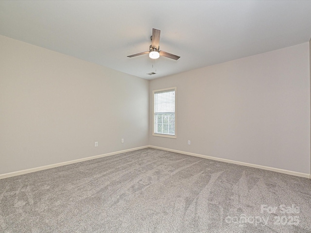 unfurnished room with ceiling fan and carpet