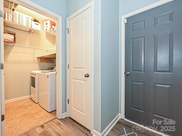 laundry area with light wood-type flooring and independent washer and dryer