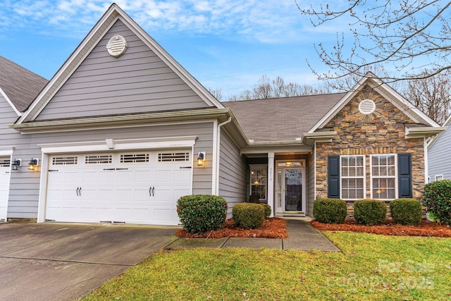 view of front of property featuring a garage and a front yard