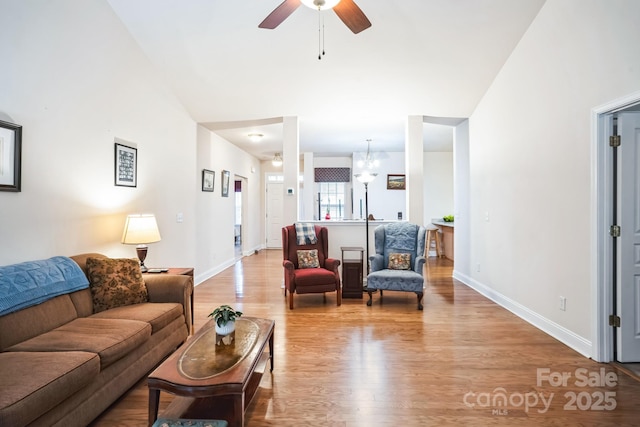 living room featuring ceiling fan and light hardwood / wood-style flooring