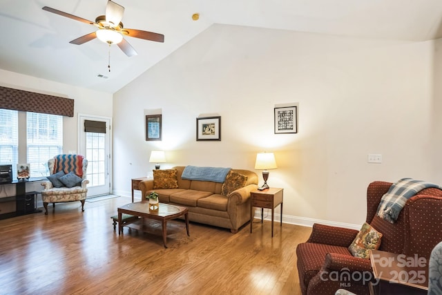 living room with ceiling fan, wood-type flooring, and high vaulted ceiling