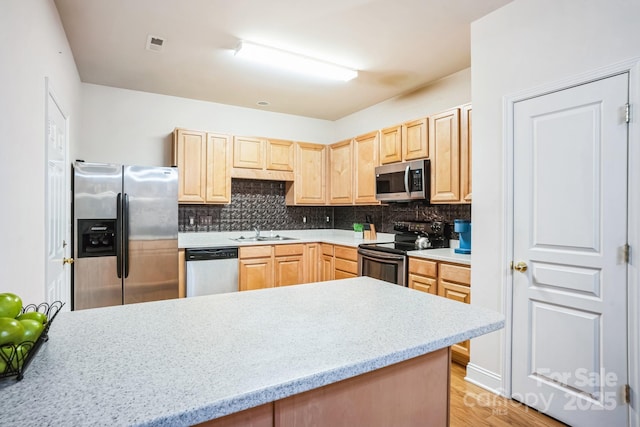 kitchen featuring sink, decorative backsplash, stainless steel appliances, and light brown cabinets