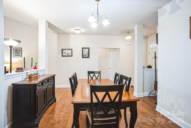 dining room with an inviting chandelier and light hardwood / wood-style floors