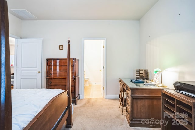 bedroom with light carpet and ensuite bath