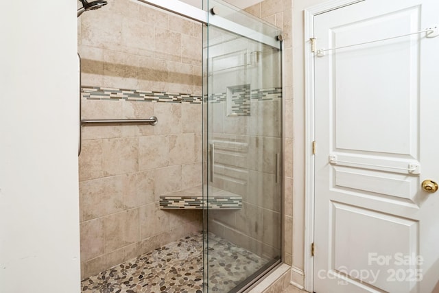 bathroom featuring a shower with door