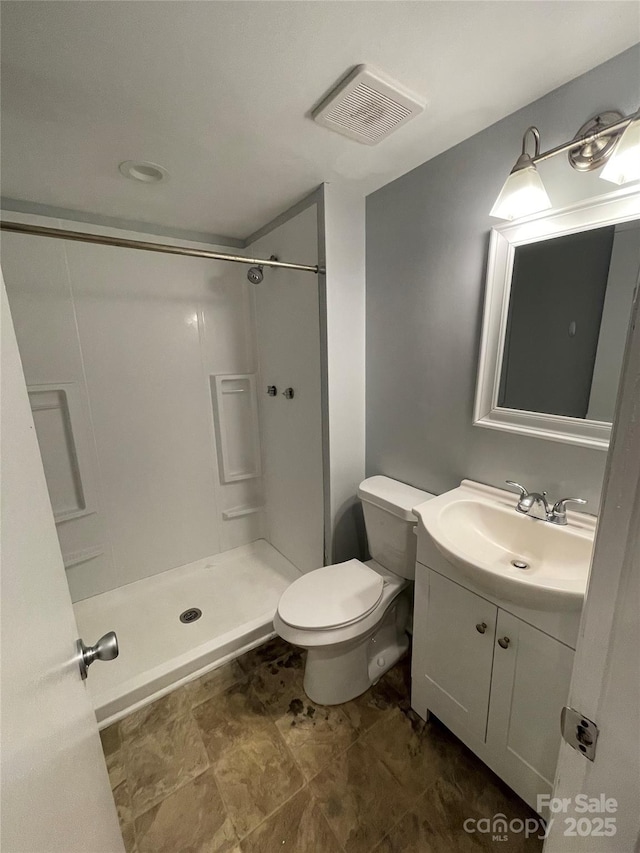 bathroom with vanity, toilet, and walk in shower