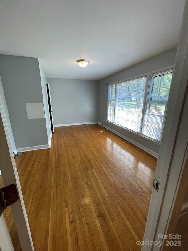 unfurnished room featuring light hardwood / wood-style floors