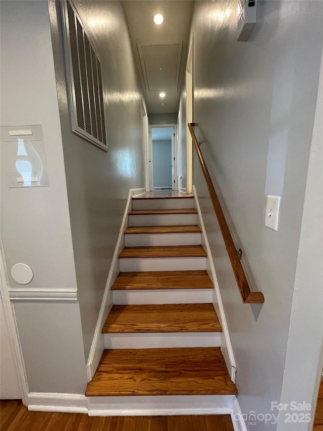 stairway with hardwood / wood-style floors