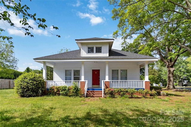 bungalow-style house featuring a porch, roof with shingles, and a front yard