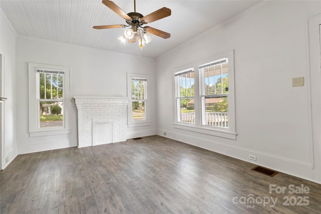 spare room featuring ceiling fan, crown molding, visible vents, and wood finished floors