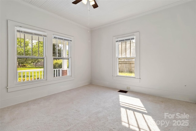 unfurnished room featuring a ceiling fan, carpet floors, visible vents, and plenty of natural light