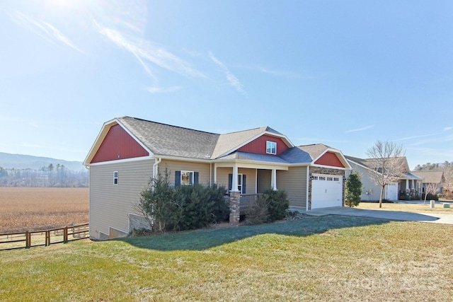 view of front of property with a garage, a porch, and a front yard