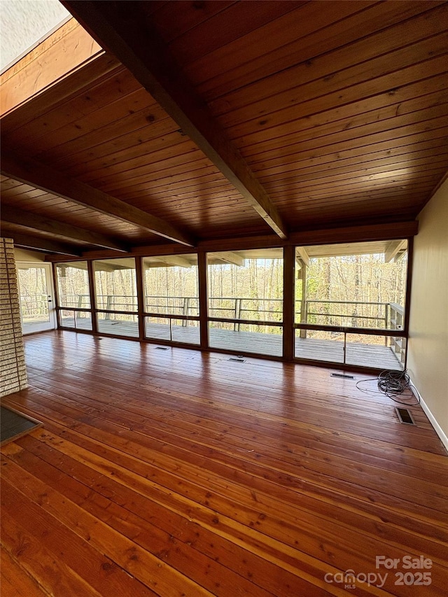 interior space featuring plenty of natural light, wood ceiling, and beam ceiling