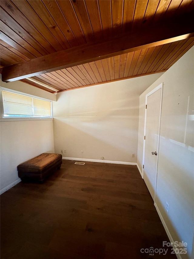 additional living space featuring beamed ceiling, wood ceiling, and dark hardwood / wood-style floors