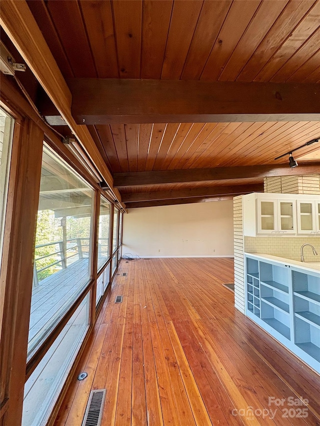 interior space featuring wood ceiling, hardwood / wood-style floors, and beam ceiling