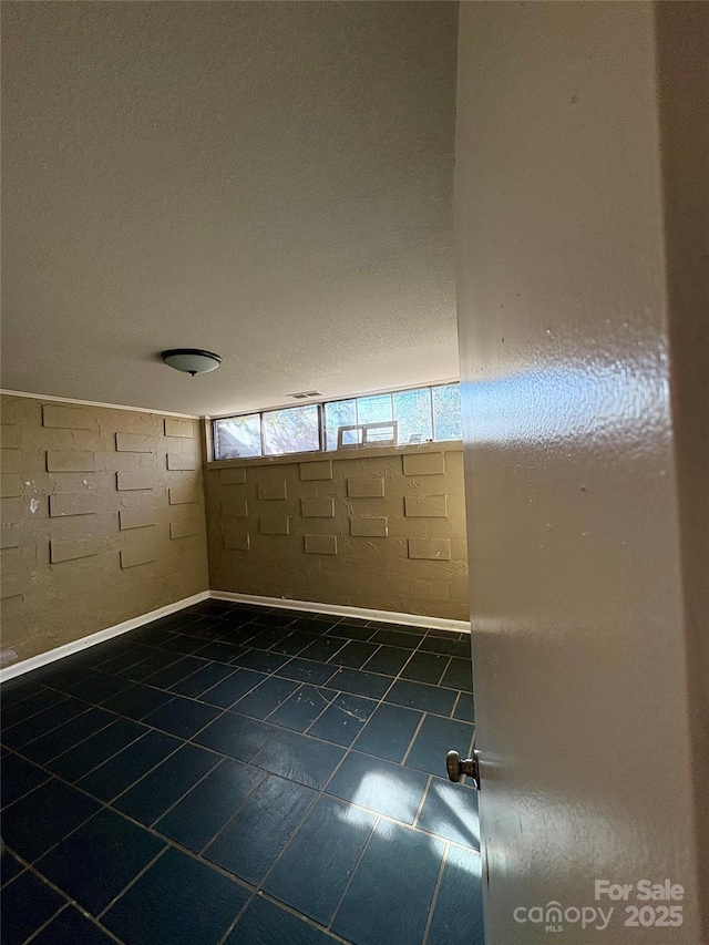 spare room featuring dark tile patterned floors