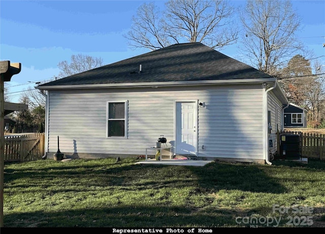 back of house with a yard and central AC unit