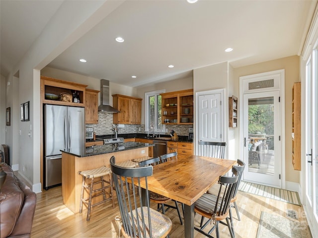 dining room featuring plenty of natural light and light wood-type flooring