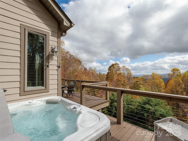 wooden terrace with a hot tub