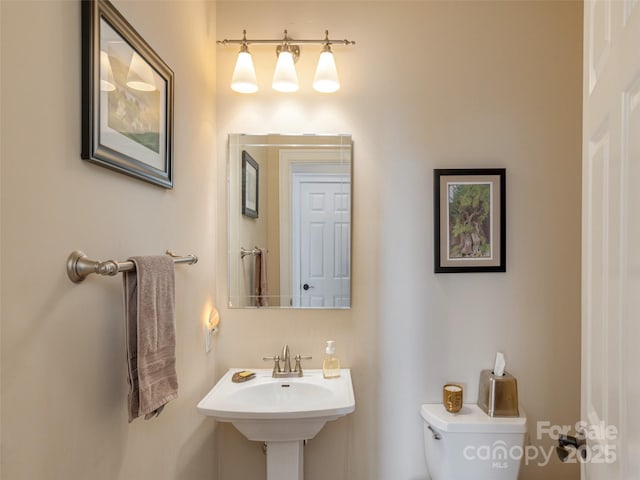 bathroom featuring toilet and sink