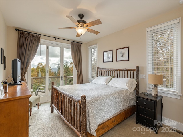 carpeted bedroom with multiple windows, access to outside, and ceiling fan