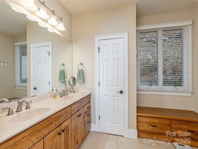 bathroom with tile patterned flooring and vanity