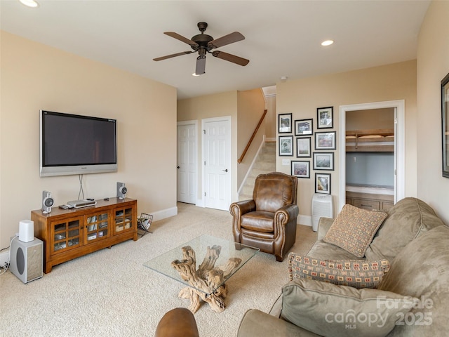 carpeted living room with ceiling fan