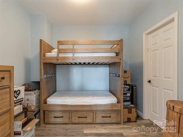 bedroom with wood-type flooring