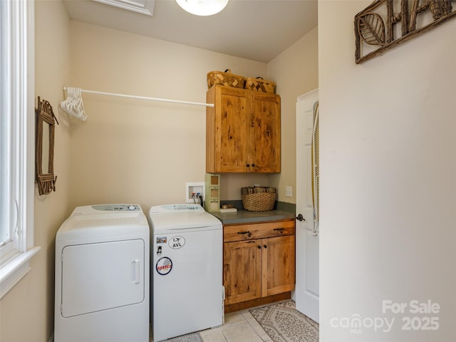 clothes washing area with cabinets, light tile patterned floors, and independent washer and dryer