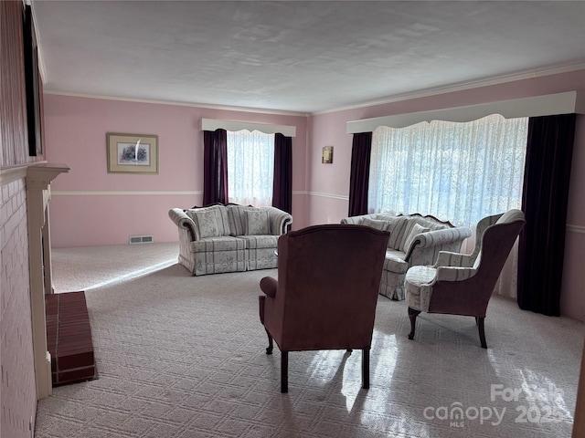 living room with crown molding, light colored carpet, and a fireplace