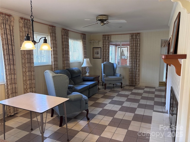 living room with ornamental molding and ceiling fan