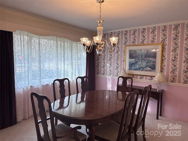 dining area with light carpet and a chandelier