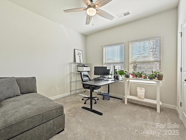 office space with ceiling fan and light carpet