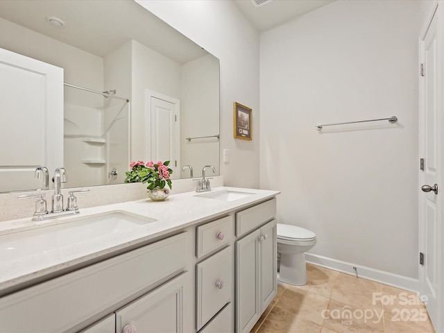 bathroom with walk in shower, vanity, toilet, and tile patterned flooring