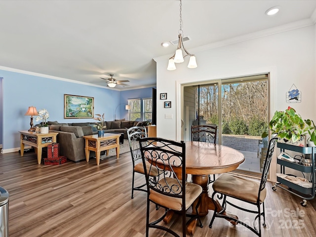 dining room with wood-type flooring, ornamental molding, and ceiling fan